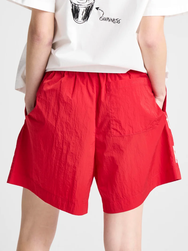 Unisex JW ANDERSON X GUINNESS SLOGAN TRACK SHORTS IN RED