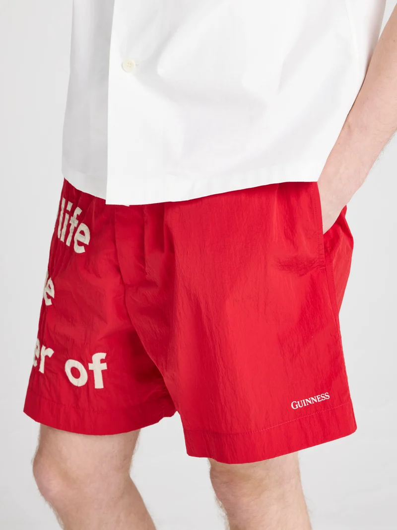 Unisex JW ANDERSON X GUINNESS SLOGAN TRACK SHORTS IN RED
