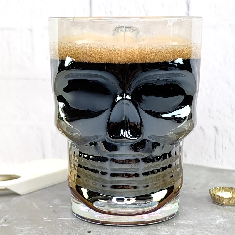 Totenkopf-Bierglas 500 ml | irisierendes Trinkglas mit Griff in Knochenform