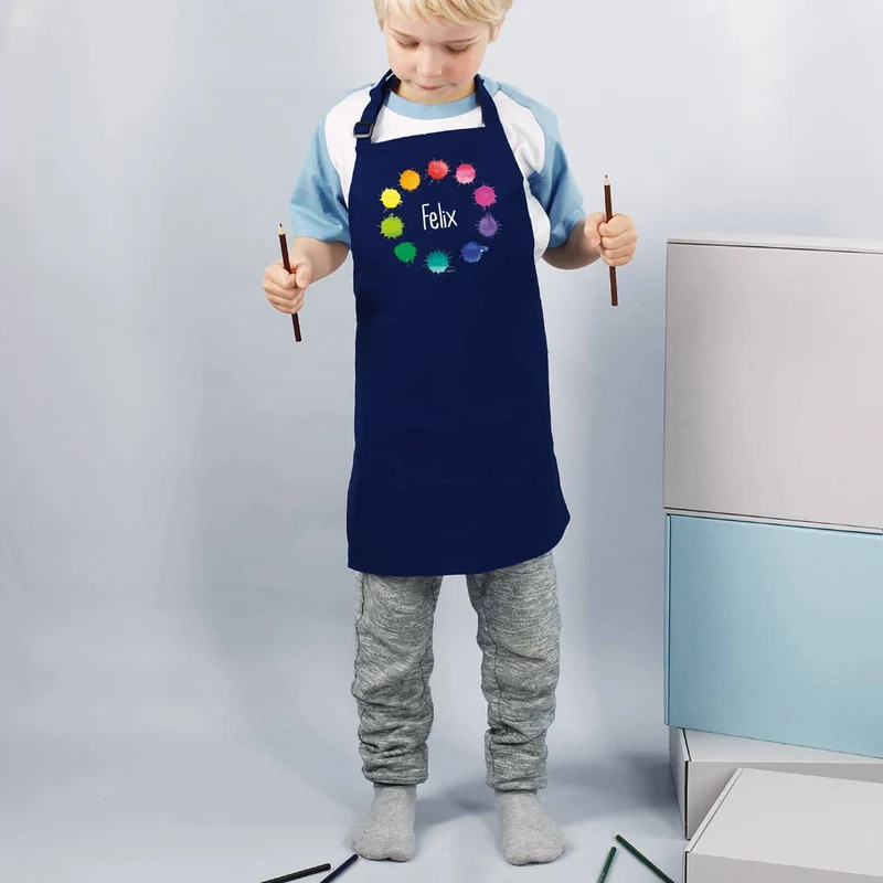 Dunkelblaue Kinderschürze mit Namensaufdruck und Farbklecks-Motiv